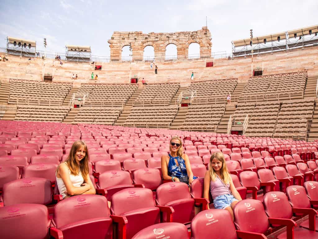caz and girls sitting in empty verona arena theater seats