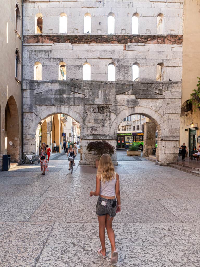 savannah in front of old stone Porta Borsari gate