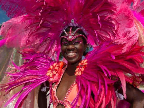 woman smiling with pink feathered headdress