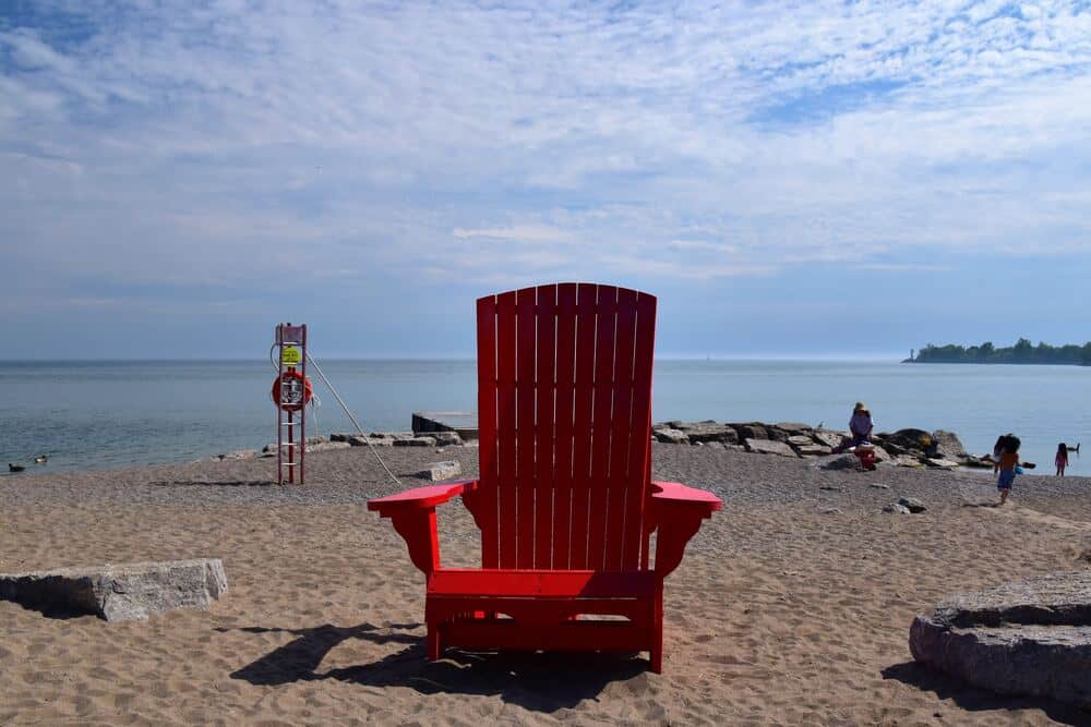 red Adirondack chair on beach