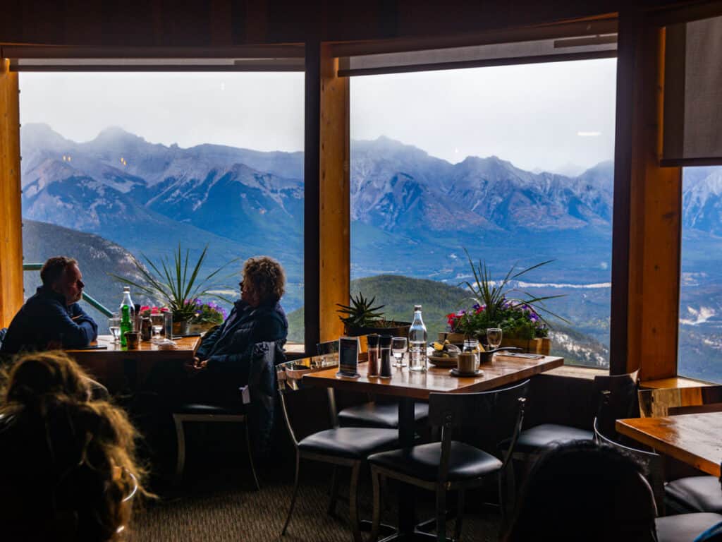 people dining in restaurant with mountain views