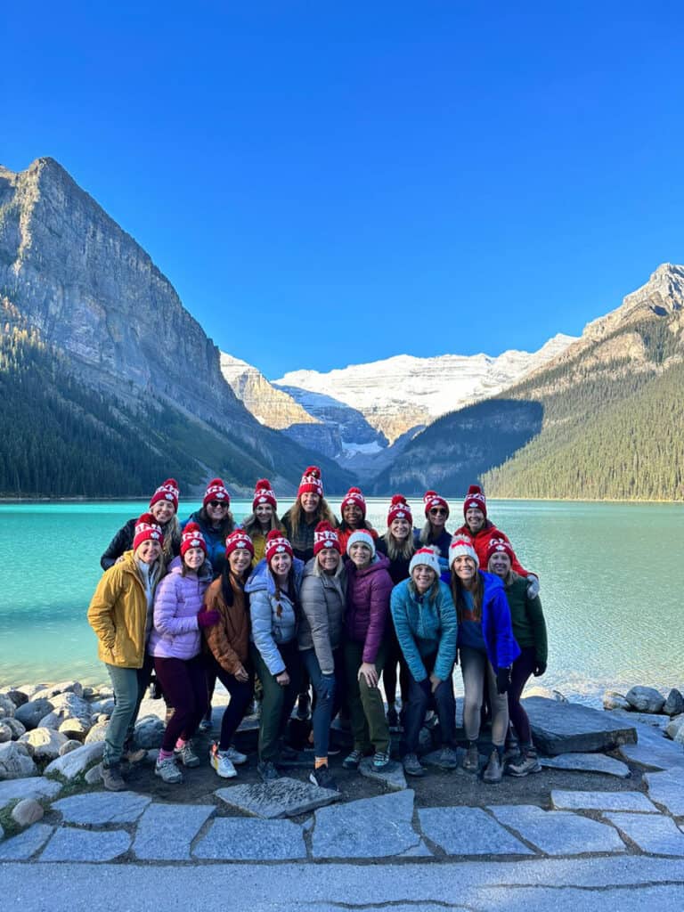 group of women posing for photo on lake louise