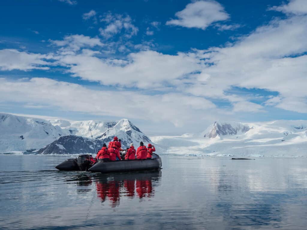 Inflatable boat full of tourists, watching for whales and seals, Antarctic Peninsula, Antarctica