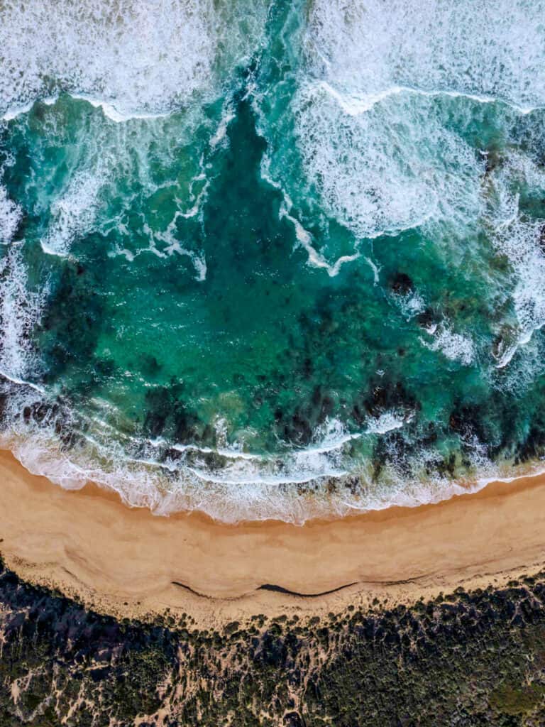 aerial view of waves crashing into sorrento beach