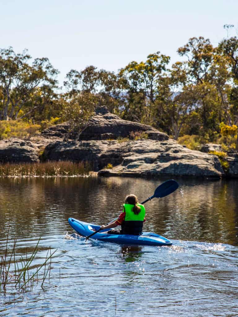 Woman enjoying an afternoon kayak through Dunns Swamp in Wollemi National Park