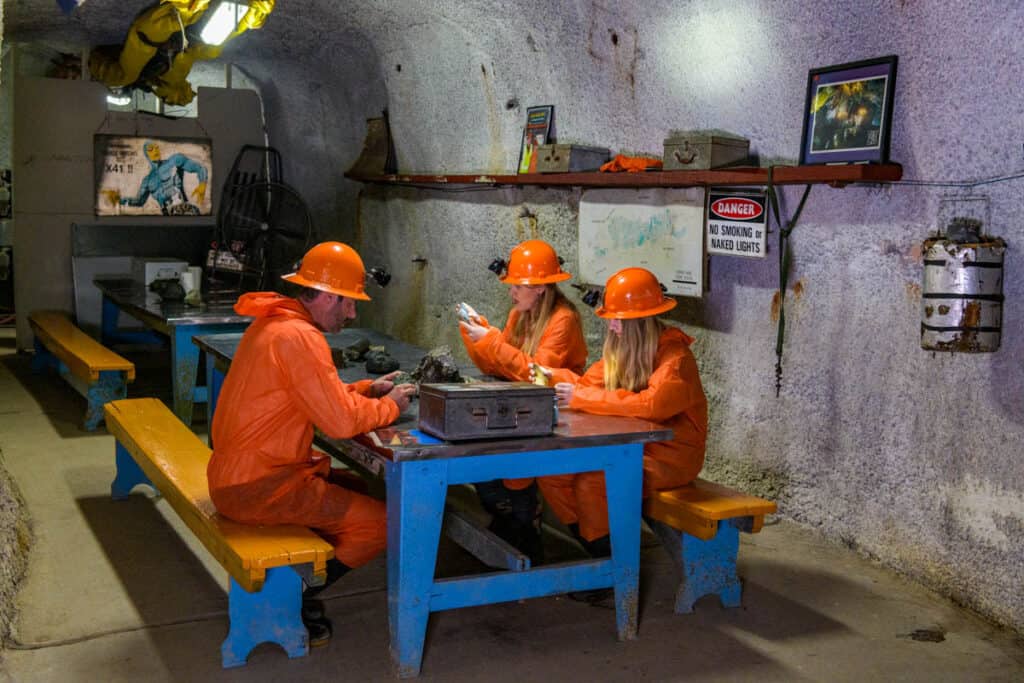 miners sitting at table underground