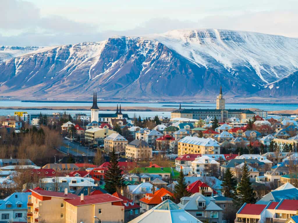 view of Reykjavik city with snowcapped mountains behind