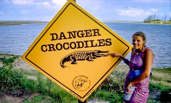 caz pointing to sign warning of crocodiles