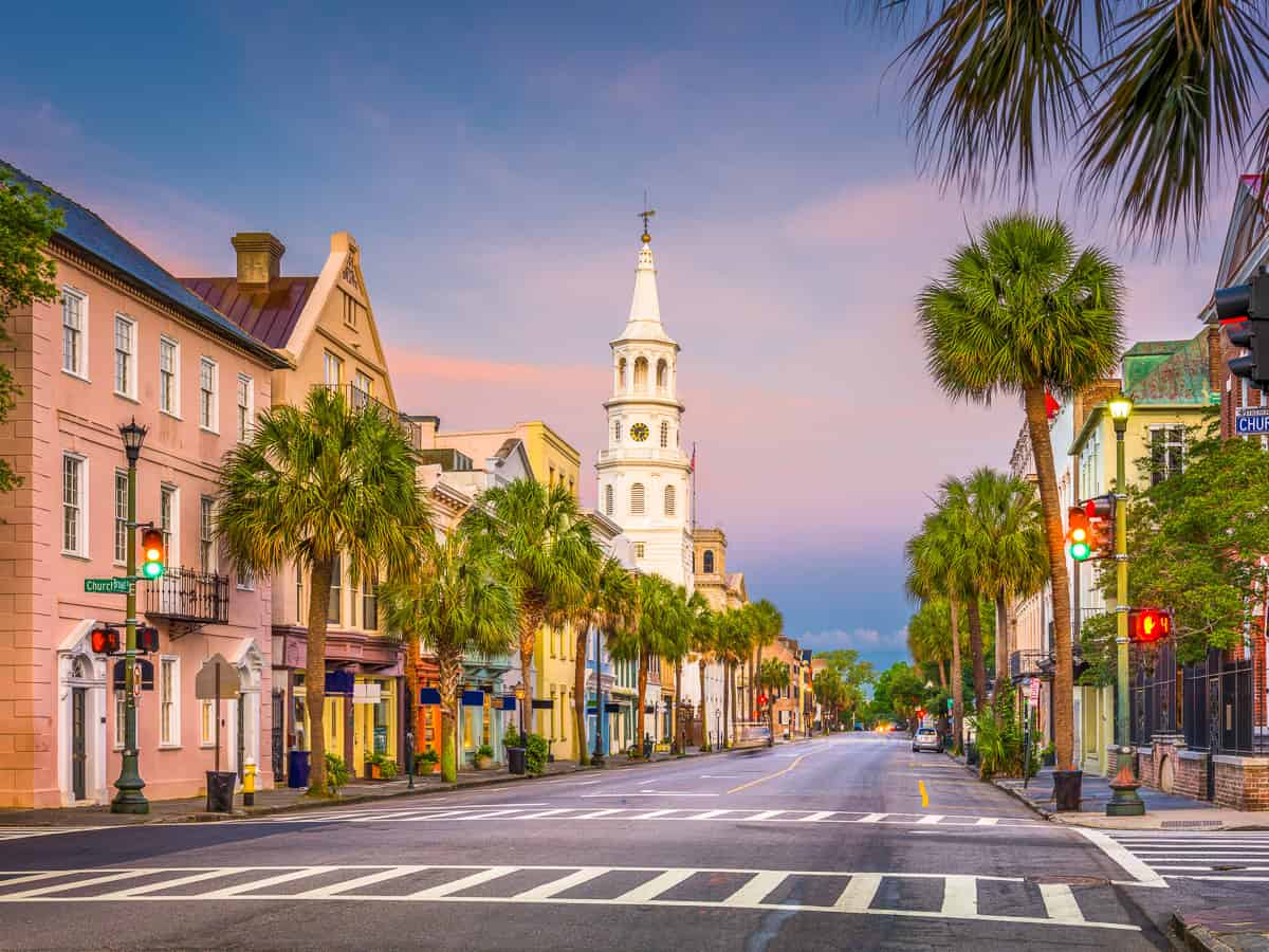 Street with palm trees and buildings in Charleston, SC. 