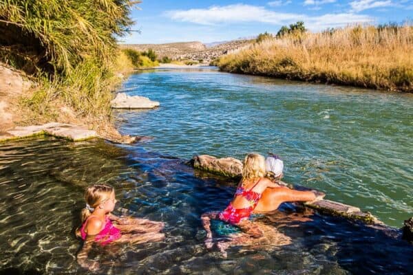 family sitting in Hot Springs in Big Bend National Park, Texas