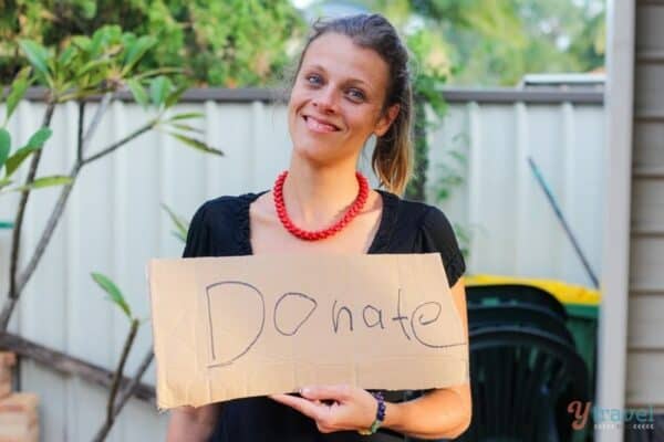 woman holding a donate sign