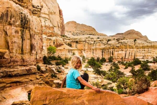 A person sitting on a rock in capitol reef park