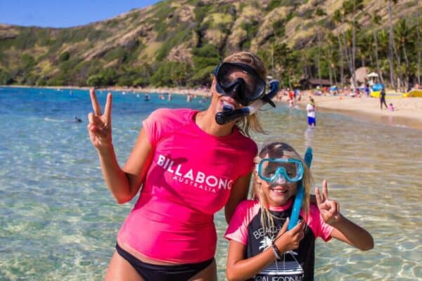 woman and child posing with snorkel masks on at Hanauma Bay