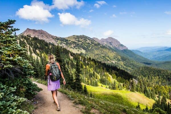 woman hiking the kahane ridge trail with mountain views