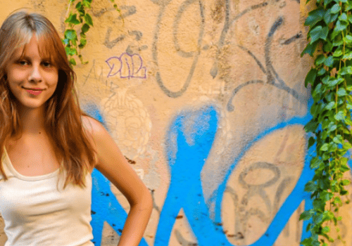 kalyra standing in front of graffiti wall in rome